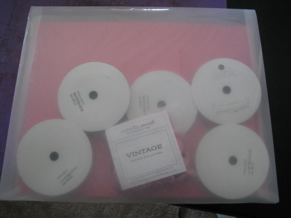 I put the ribbons and buttons behind the paper so all of the color stays together.