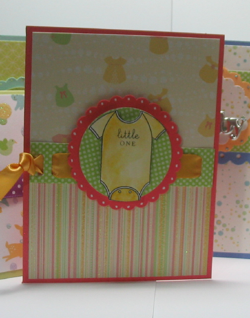 Another baby card!  This one with the DCWV Nursery girl paper, and a watercolored onsie, along...