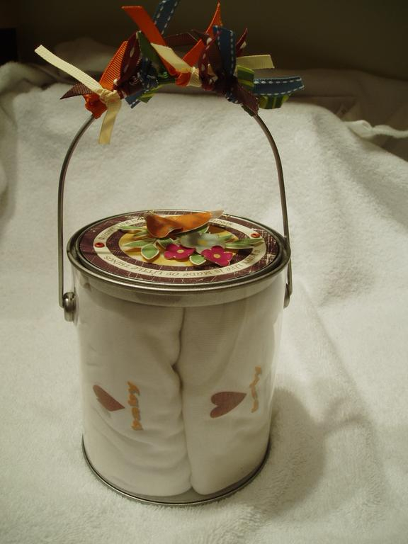 Full shot of paint can, with onesies inside.
