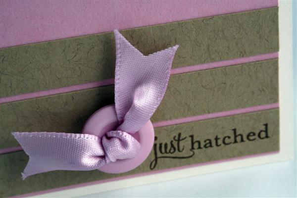 Close up of the button, ribbon, and saying.