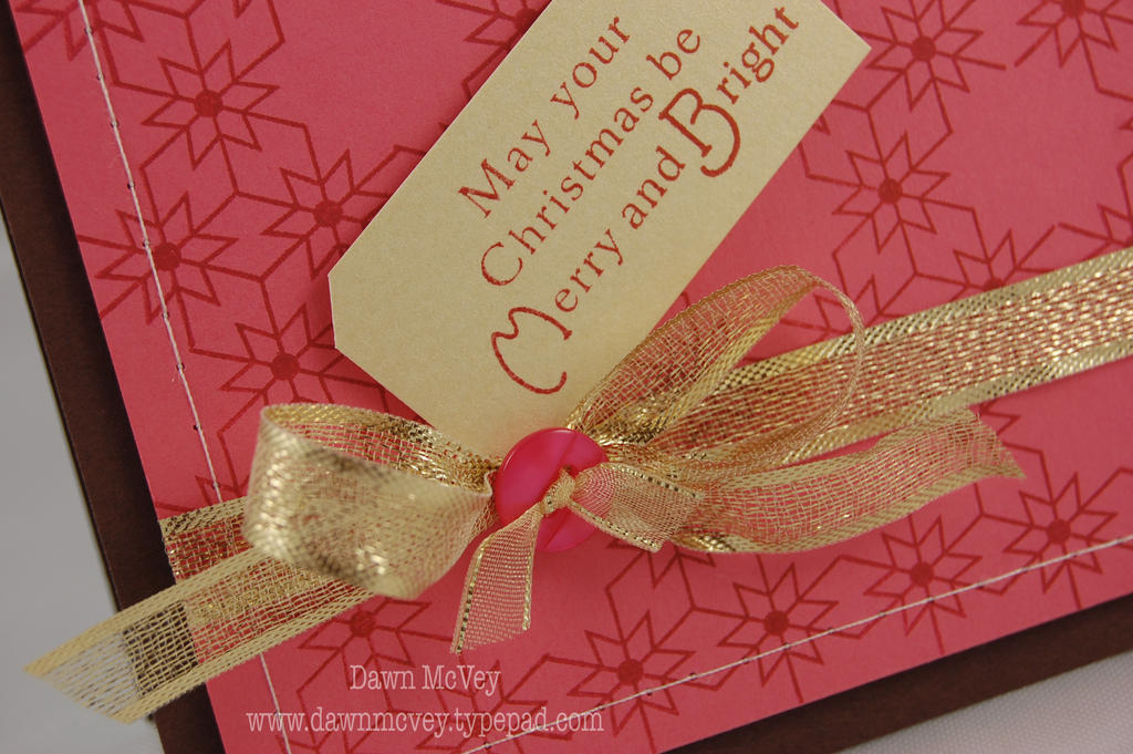 I took a small piece of the Gold Sheer Metallic Edge ribbon and ran it thru the holes in the...
