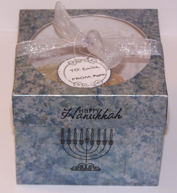 I made the box using an alcohol ink technique then I stamped images from the Mazel Tov set on it...
