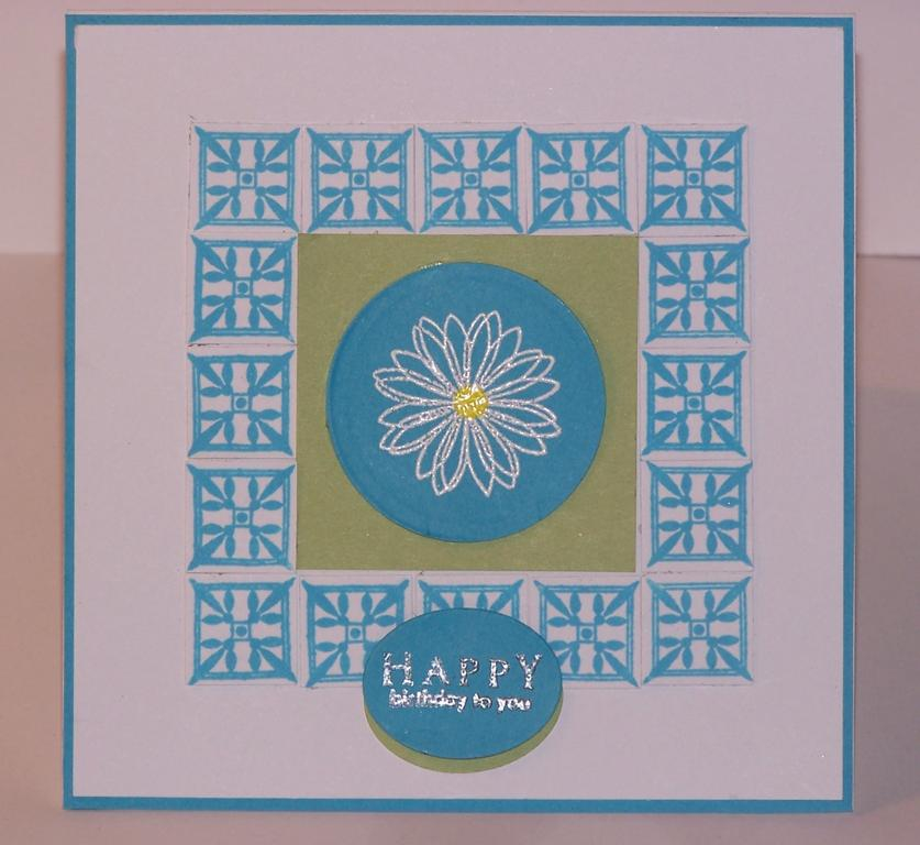 For the card. I stamped the daisy from The Garden of Life set with versamark and embossed it...