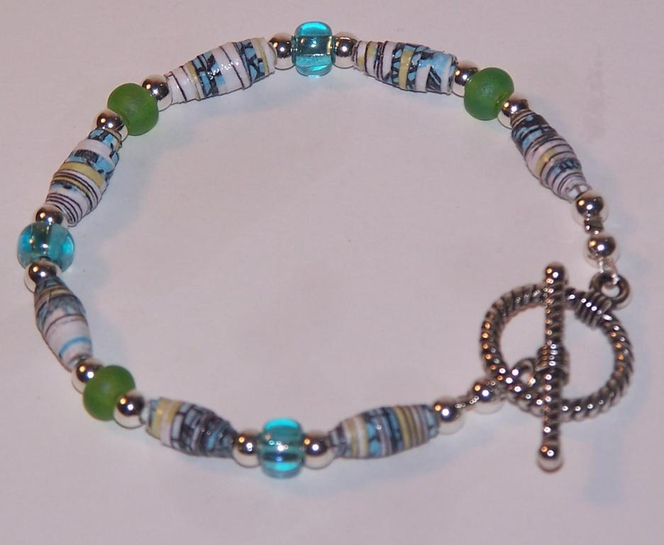 Paper beads were made with images from Remember. Instructions for making the paper beads on...