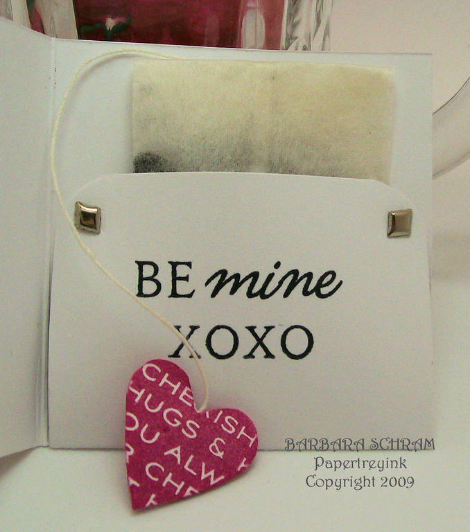 Inside card is a single tea bag with a heart tag attached to string end. Brads hold folded flap...