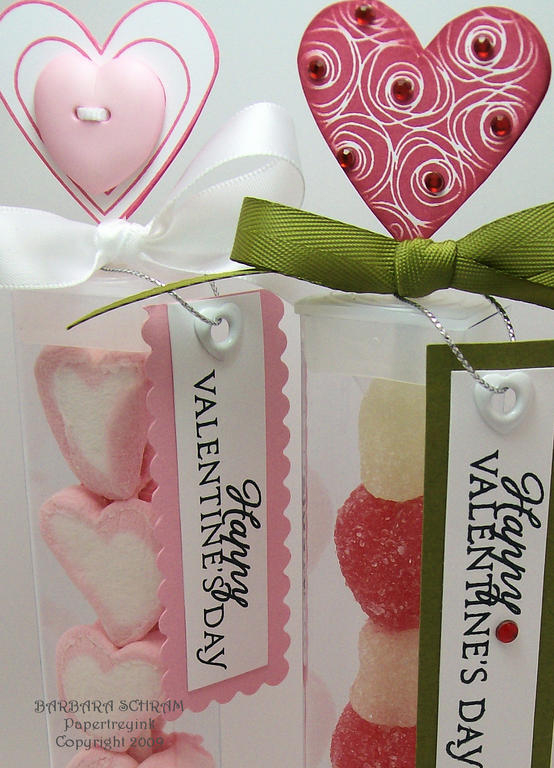 A closer look reveals adhesive gems on the red tube treat heart and a button on the pink tube...