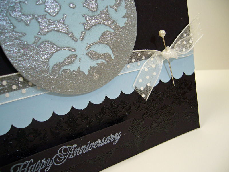 Here is a close-up of the embossing and the silver sprayed masked image.