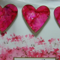 I just sponged some alcohol inks on glossy paper, punched out hearts... stamped the sentiment from Heart Prints (or was that aheart Prints Sentiments??) used an organdy ribbon and called it done!