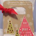 I used a die cut gift bag and created a Christmas tree scene.  I wanted a rustic country feel with the traditional red and green Christmas colors.