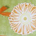 This card uses a "stained glass" technique - embossed on vellum cardstock and then rubbed with ink.  I cut a hole for the flower to show off its color against the white cardstock.  The flower is...