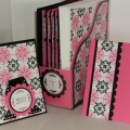 Closeup view of the two card designs and the assembled file holder. The Hibiscus Burst file holder slides inside the Clearly Creative file folder to provide more stability to the piece.